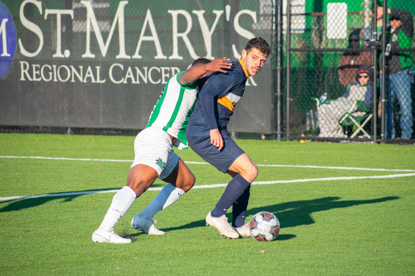 West Virginia forward Rodrigo Robles Grajera scans the field while under heavy pressure from a Marshall defender at Hoops Family Field on Nov. 24, 2019.